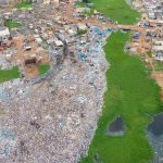 A lagoon being filled with rubbish to reclaim the land